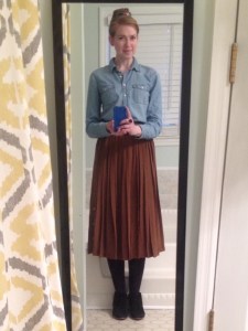 Chambray shirt with pleated silk skirt, black tights, and black suede ankle boots